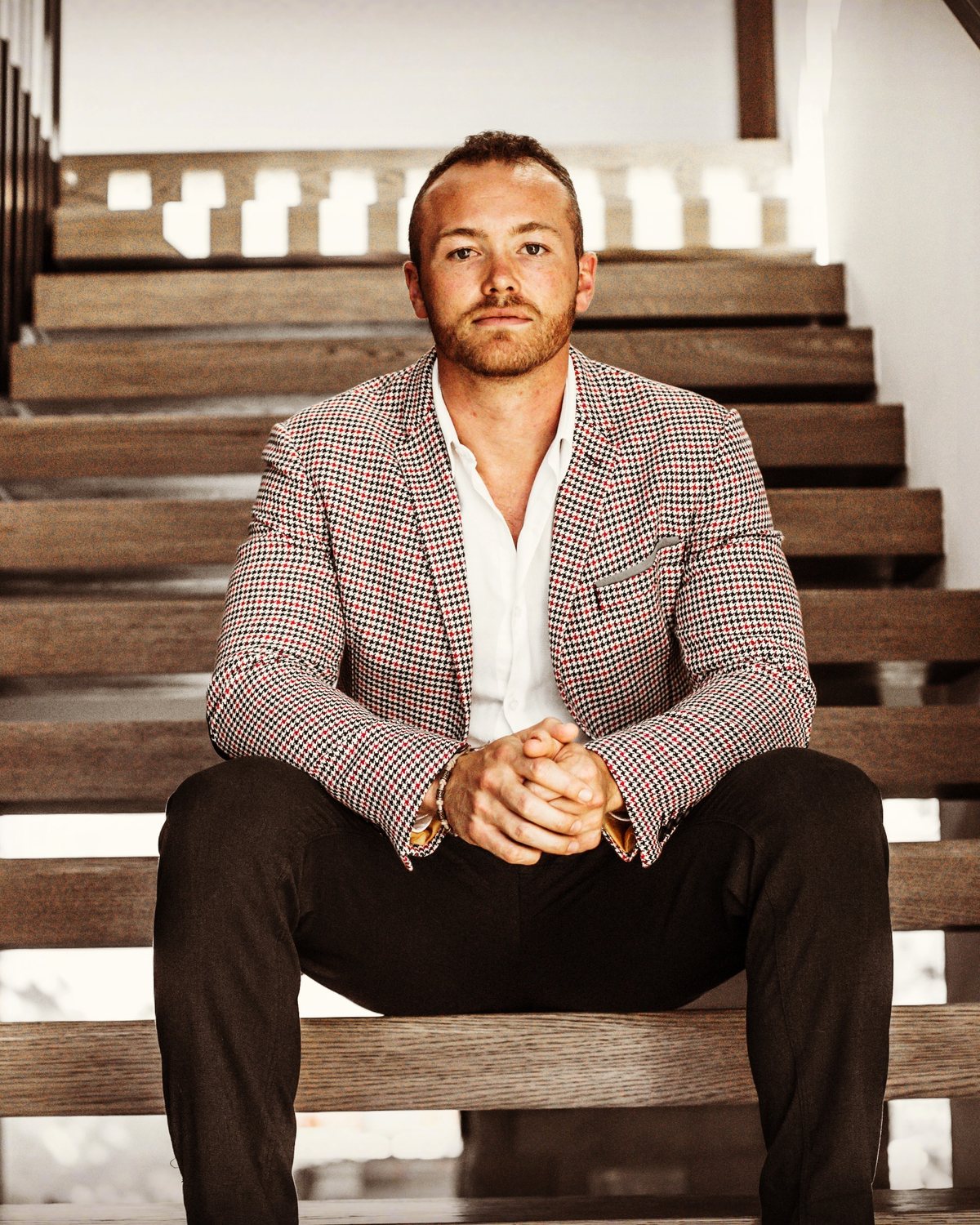 Oliver Thornton seated on a staircase